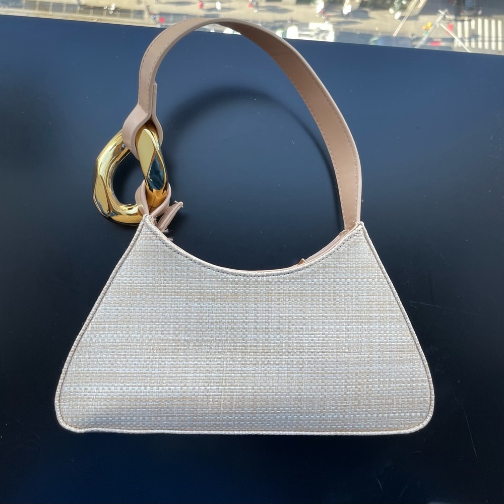 Woven straw purse with tan leather strap, gold hardware, zip closure